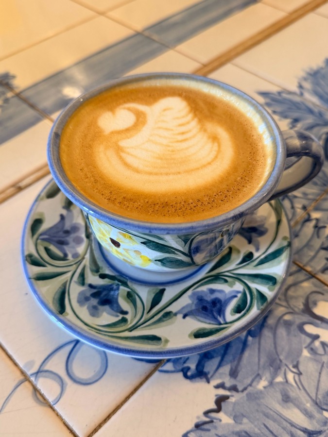 Coffee served in a hand-painted ceramic cup